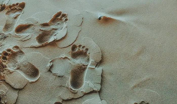 沙滩上的人脚印照片
