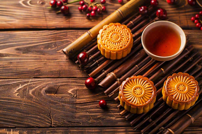 中国传统糕点月饼竹制托盘上的茶杯中秋节摄影图